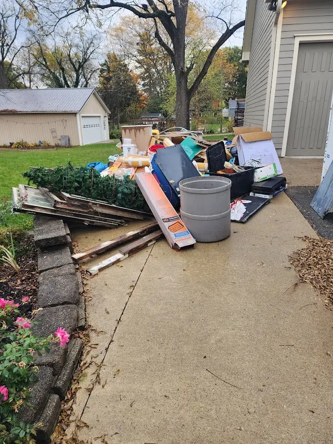 Dumpster being loaded with debris for Roofing Dumpster Rental in Paola